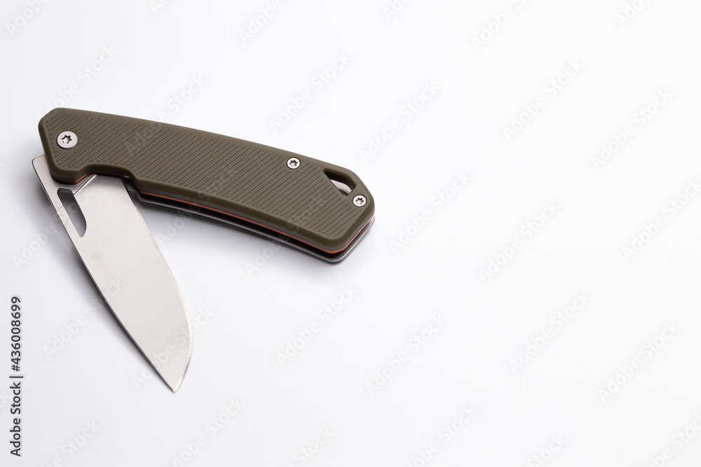 A small folding hunting knife isolated on the white background. Photo taken under soft artificial light. A small folding hunting knife isolated on the white background. Photo taken under soft artificial light.