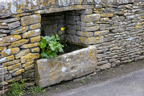 old stone wall with animal watering trough