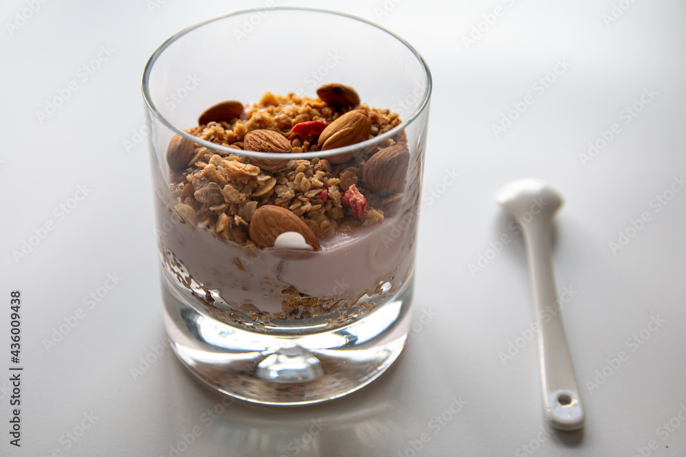 Isolated photo of diet yogurt with granola and almond, healthy breakfast concept with muesli or cereal Isolated photo of diet yogurt with granola and almond, healthy breakfast concept with muesli or cereal