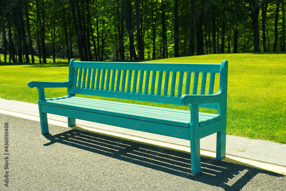 Beautiful view of light blue wooden bench in park Beautiful view of light blue wooden bench in park