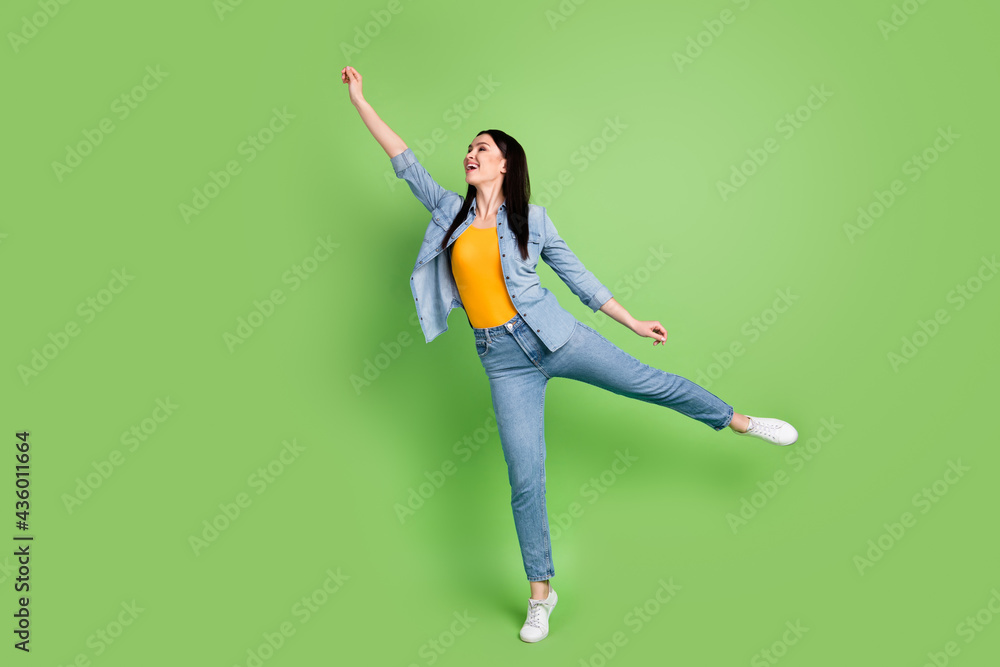 Full size profile side photo of young charming dreamy smiling woman hold invisible umbrella isolated on green color background