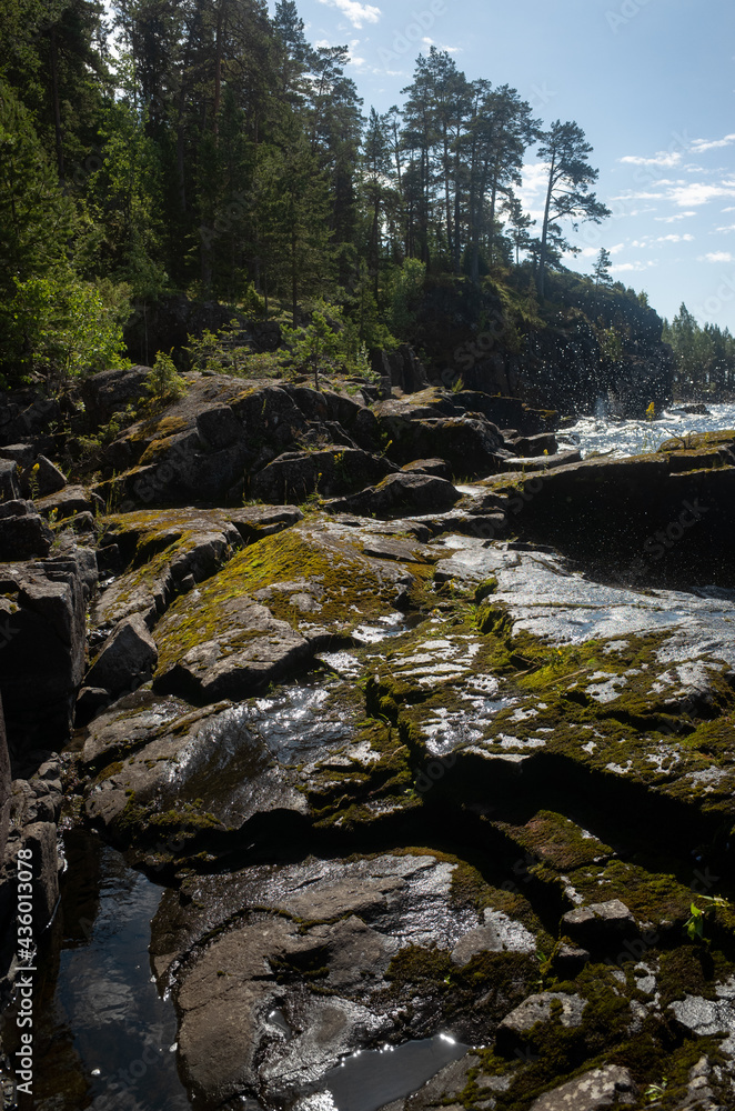 Wildlife of the Valaam nature reserve. Holy Island. Stone shore against which the waters of Lake Ladoga beat. Wildlife of the Valaam nature reserve. Holy Island. Stone shore against which the waters of Lake Ladoga beat.