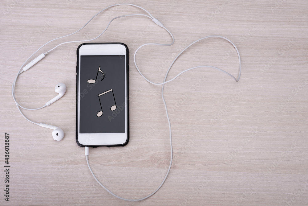 Musik hören mit dem Mobiltelefon, Handy, Kopfhörer, Noten, Stock Photo |  Adobe Stock