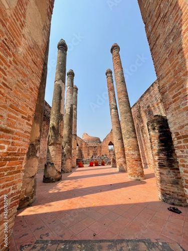 The ancient temple in which the ruins are lined with pillars on either side and the monks turn their backs to meditate.
