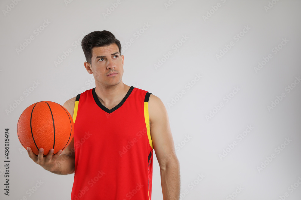 Basketball player with ball on grey background. Space for text Basketball player with ball on grey background. Space for text