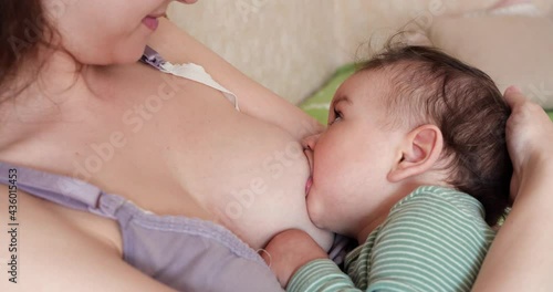 Woman breastfeeding newborn baby. Baby eating mother's milk. Concept of lactation infant photo