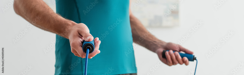 cropped view of sportsman with jump rope, banner cropped view of sportsman with jump rope, banner
