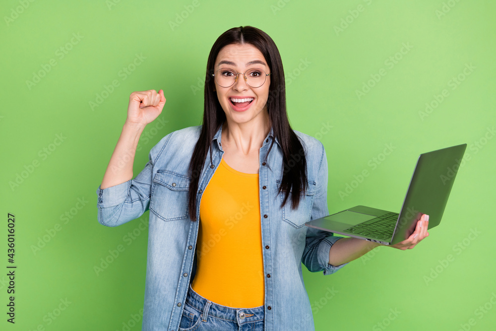 Photo of hooray nice brown hairdo lady work laptop wear spectacles jeans shirt orange top isolated on green color background Photo of hooray nice brown hairdo lady work laptop wear spectacles jeans shirt orange top isolated on green color background