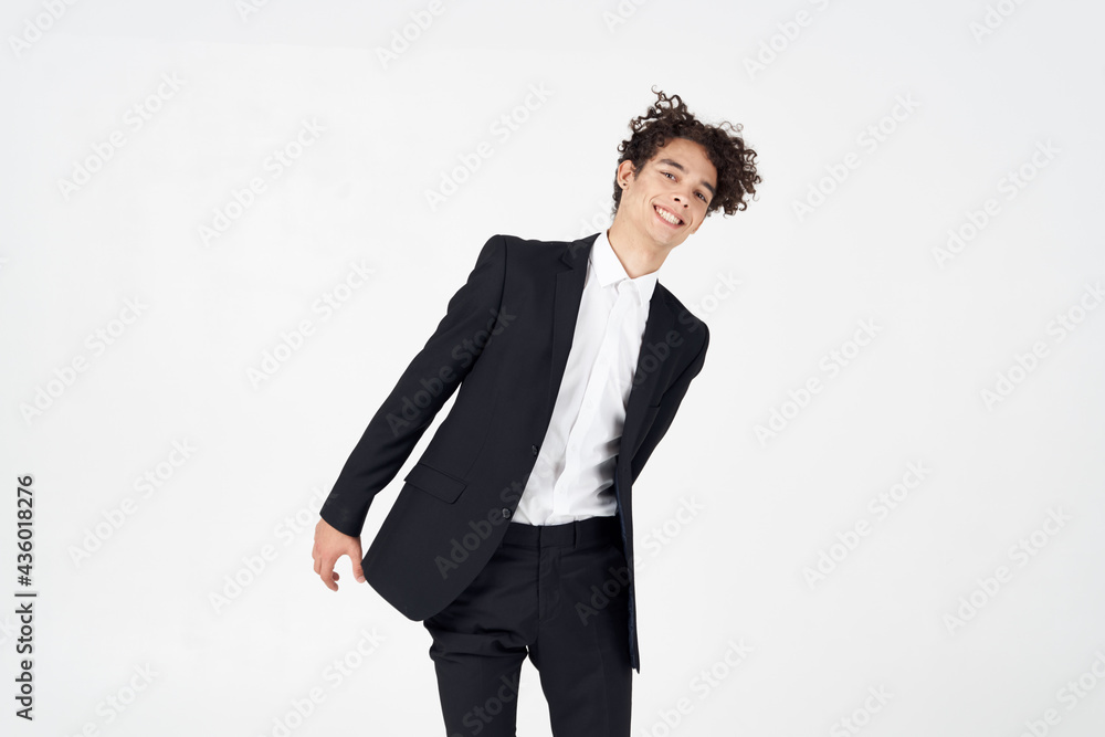 young guy in a classic suit on a light background curly hair portrait cropped view young guy in a classic suit on a light background curly hair portrait cropped view