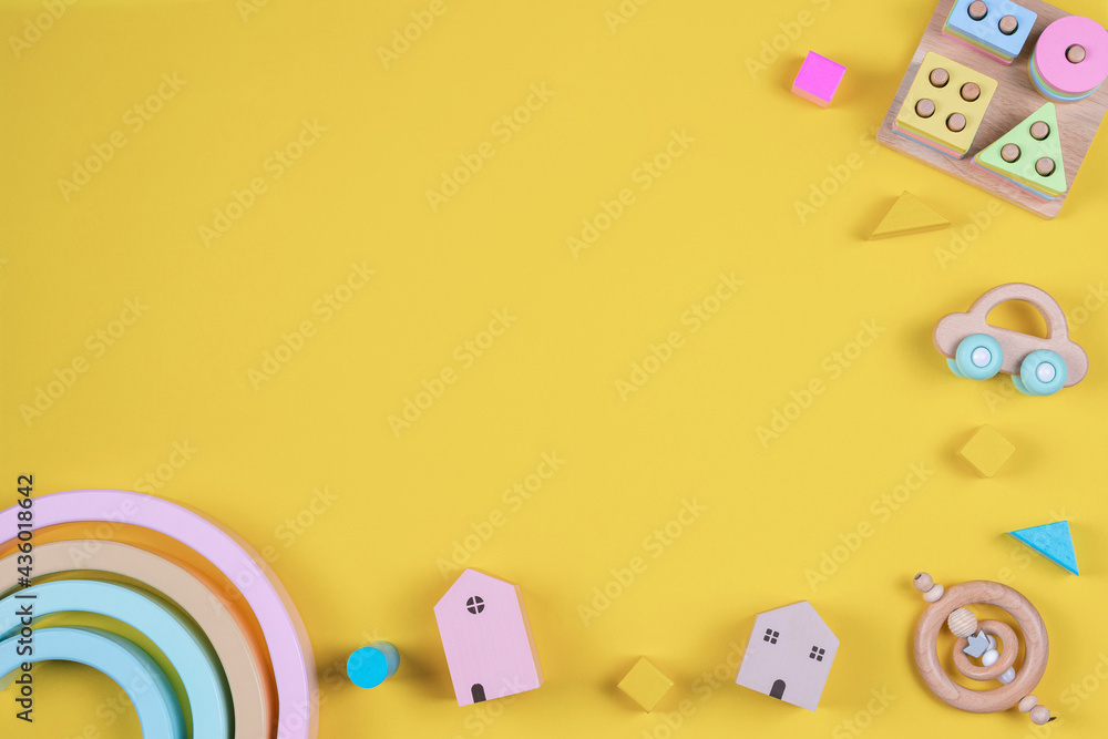 Baby kids toys frame on yellow background. Top view. Flat lay. Copy space for text