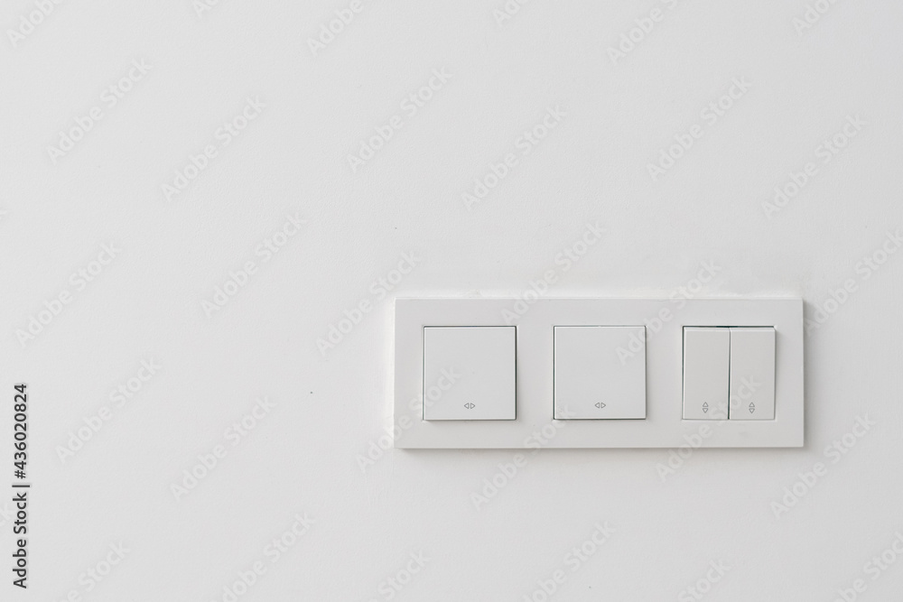 White three light switch panel on hotel wall foto de Stock | Adobe Stock