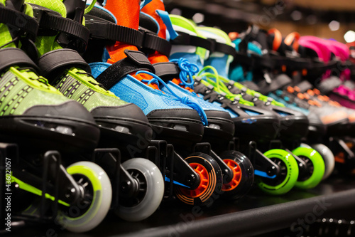 Bild auf Leinwand Photo of various colored roller skates standing on sport store shelf