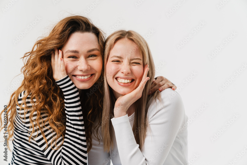 Young two women laughing while making fun together on camera Young two women laughing while making fun together on camera