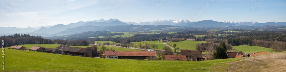 wide mountain panorama, view from Irschenberg hill to bavarian alps and rural village and landscape