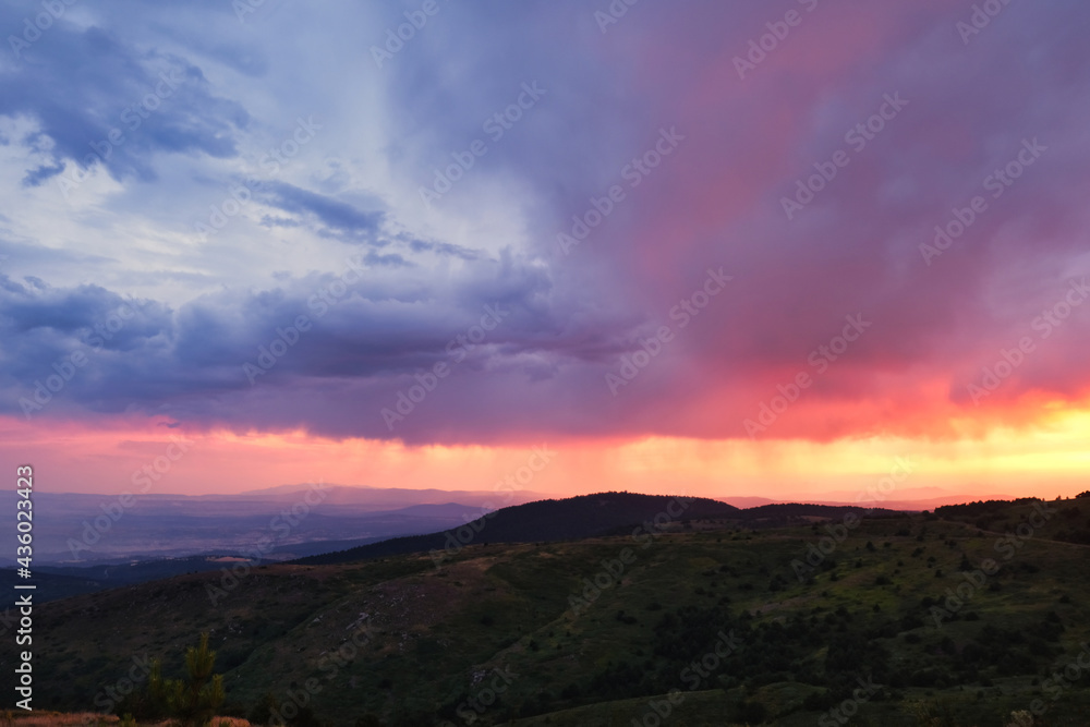 rain clouds above the mountain at sunset