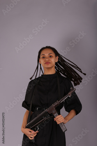 Pretty curly woman with vintage german submachine gun