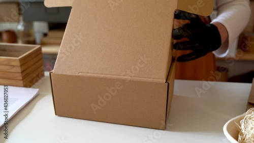 Business owner packing products for shipping photo