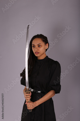 Beautiful woman holding a sword katana