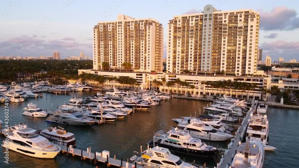 Aerial Shot Of Nautical Vessels Moored In Sea During Sunset, Drone Flying Forward Over Hotel Buildings Against Sky During Sunset - Miami, Florida Aerial Shot Of Nautical Vessels Moored In Sea During Sunset, Drone Flying Forward Over Hotel Buildings Against Sky During Sunset - Miami, Florida