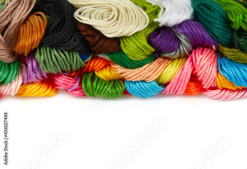 A set of multicolored threads for embroidery isolated on white bacground photo