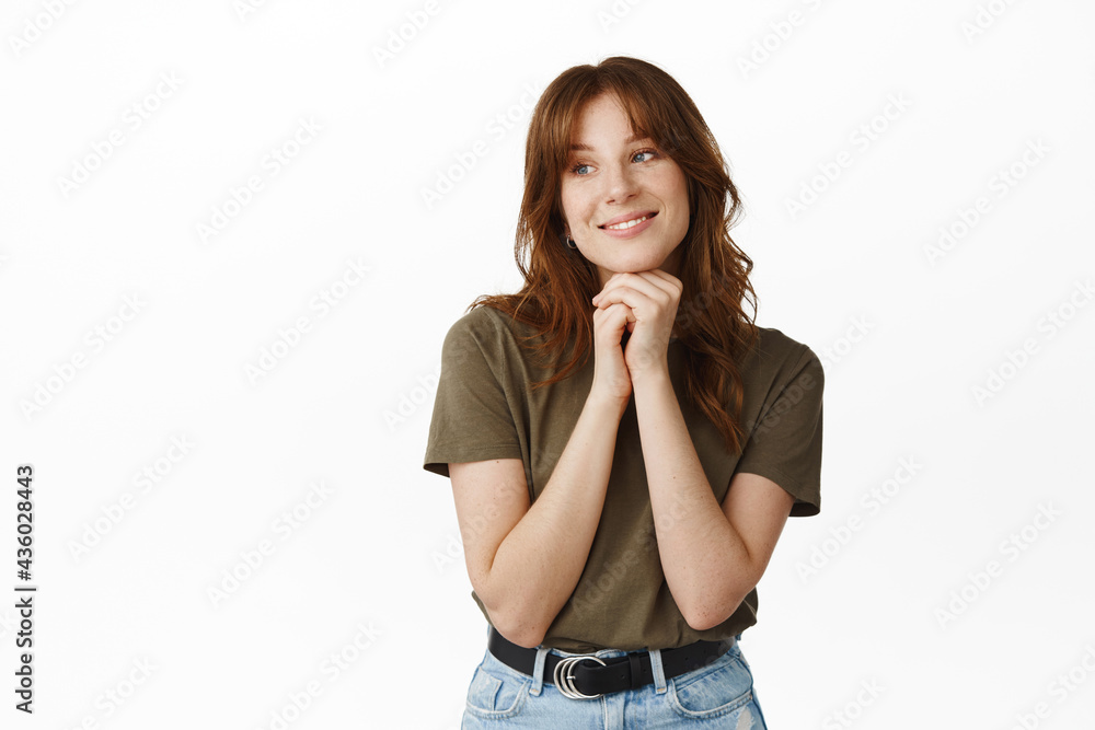 Beauty girl with white smile, looking romantic and gazing aside, showing natural facial skin with clean glowing face, standing in olive t-shirt and jeans against white background Beauty girl with white smile, looking romantic and gazing aside, showing natural facial skin with clean glowing face, standing in olive t-shirt and jeans against white background