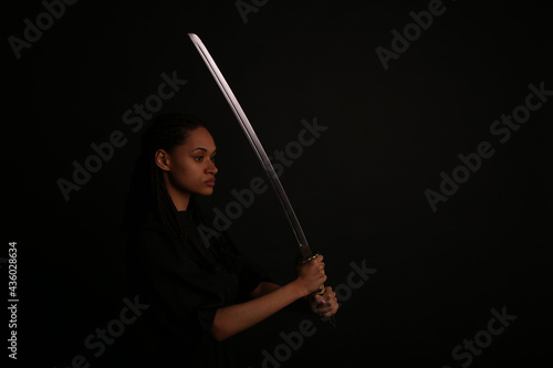 Beautiful woman holding a sword katana