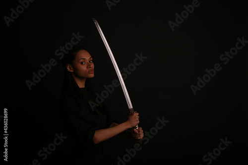 Beautiful woman holding a katana sword