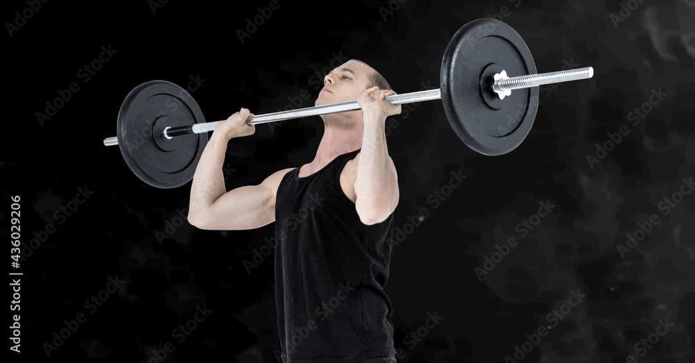 Composition of caucasian male weightlifter with barbell with smoke on black background Composition of caucasian male weightlifter with barbell with smoke on black background