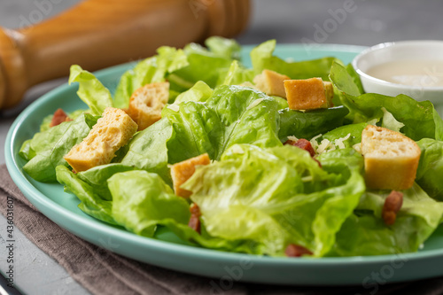 Caesar salad with croutons and bacon.