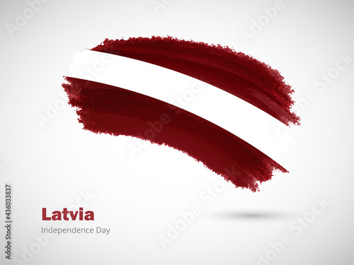 Happy independence day of Latvia with artistic watercolor country flag background. Grunge brush flag illustration