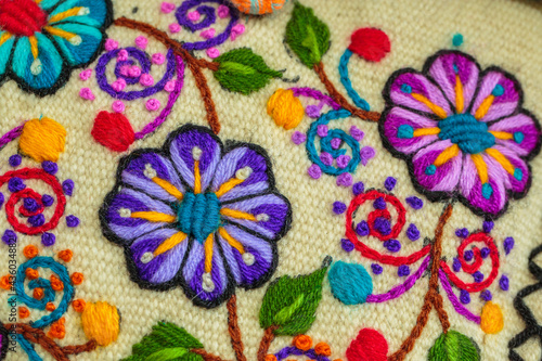 Peruvian crafts: Embroidered flower ornaments on a handmade fabric