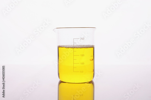 Clear yellow liquid is poured into beaker