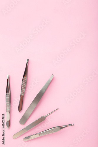 Beauty and fashion concept - tools for Eyelash Extension Procedure. Tweezers on pink background. Copyspace mockup