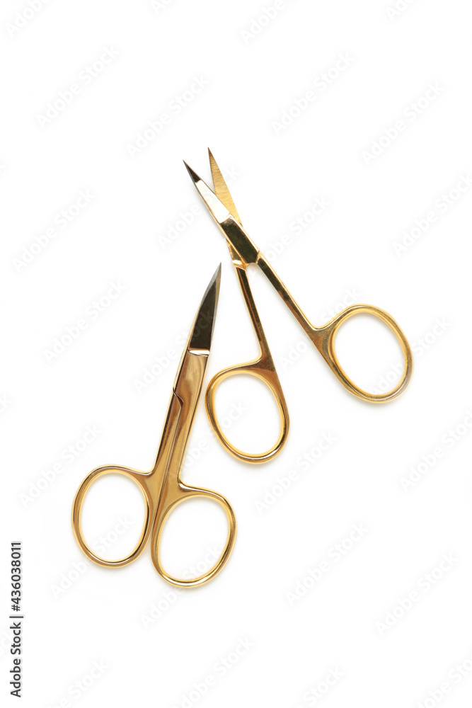 Small gold manicure scissors isolated on white background Small gold manicure scissors isolated on white background