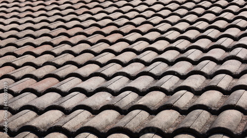 Close-up of old tiled roof on a sunny day. Selective focus