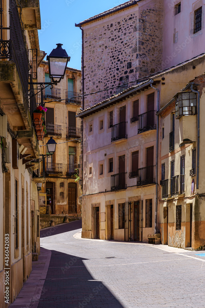 Street of an old town with stone houses and narrow alley. Sepulveda Segovia.