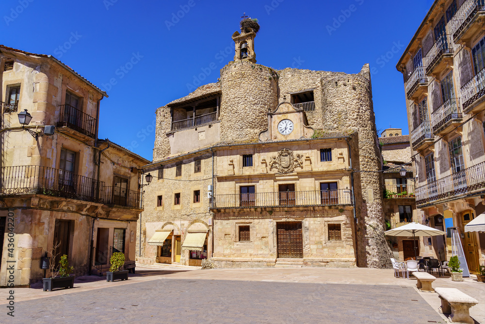 Main square of the medieval town of Sepulveda with the Town Hall building and a stork's nest above it.