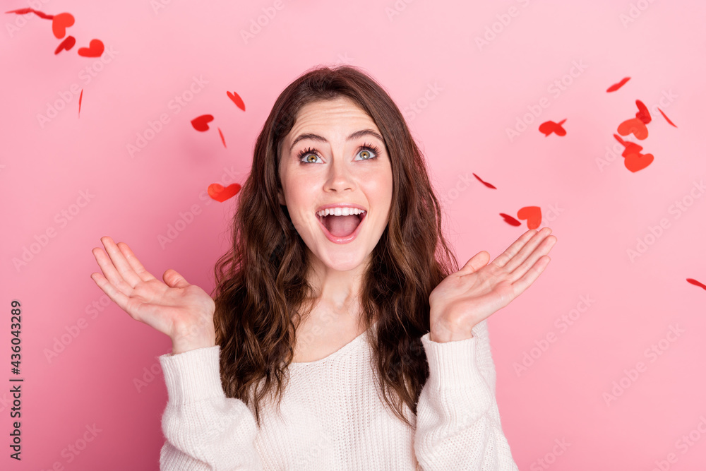 Photo of young excited girl happy positive smile amazed surprised fly heart serpentine isolated over pastel color background Photo of young excited girl happy positive smile amazed surprised fly heart serpentine isolated over pastel color background
