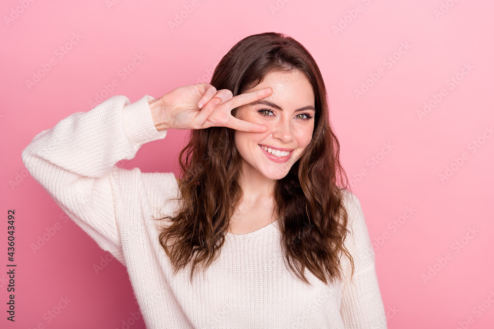 Photo of young attractive girl happy positive smile show peace cool v-sign isolated over pastel color background Photo of young attractive girl happy positive smile show peace cool v-sign isolated over pastel color background