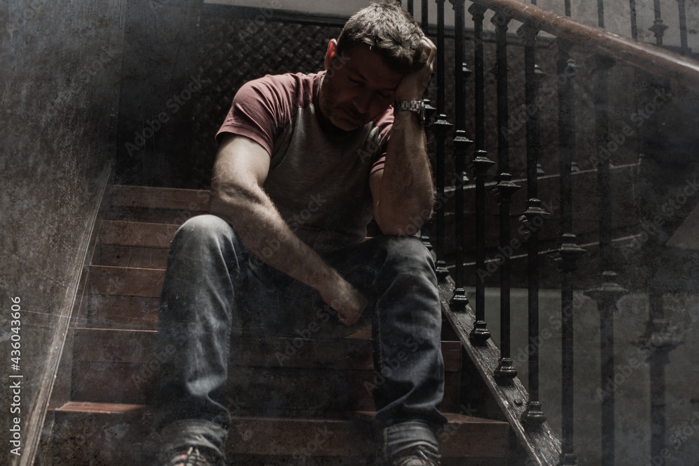 unemployment and divorce - dramatic lifestyle portrait of sad and depressed man on his 40s sitting indoors on staircase thoughtful and worried suffering depression problem unemployment and divorce - dramatic lifestyle portrait of sad and depressed man on his 40s sitting indoors on staircase thoughtful and worried suffering depression problem