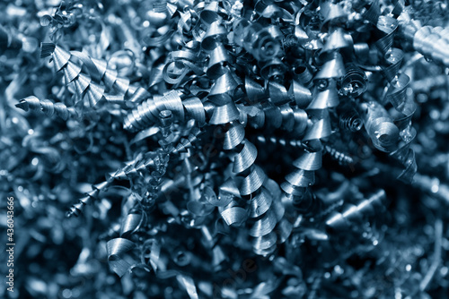 Close-up scene of metal scrap from turning process. The pile of lathe chips.