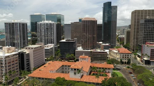 Cinematic 4K panning aerial drone shot of downtown Honolulu with white Manu-o-Ku birds abundant over the Iolani Palace photo