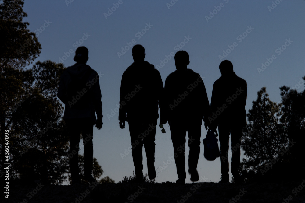 silhouettes of friends walking