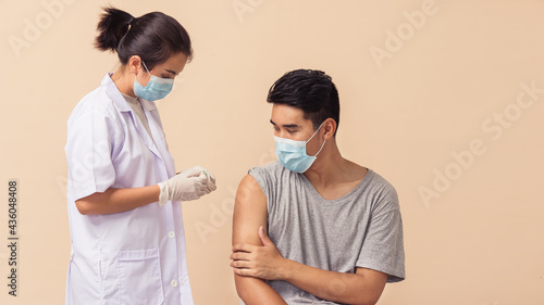 Asian people, Female doctor healthcare during putting bandage on arm of a woman after giving vaccination.