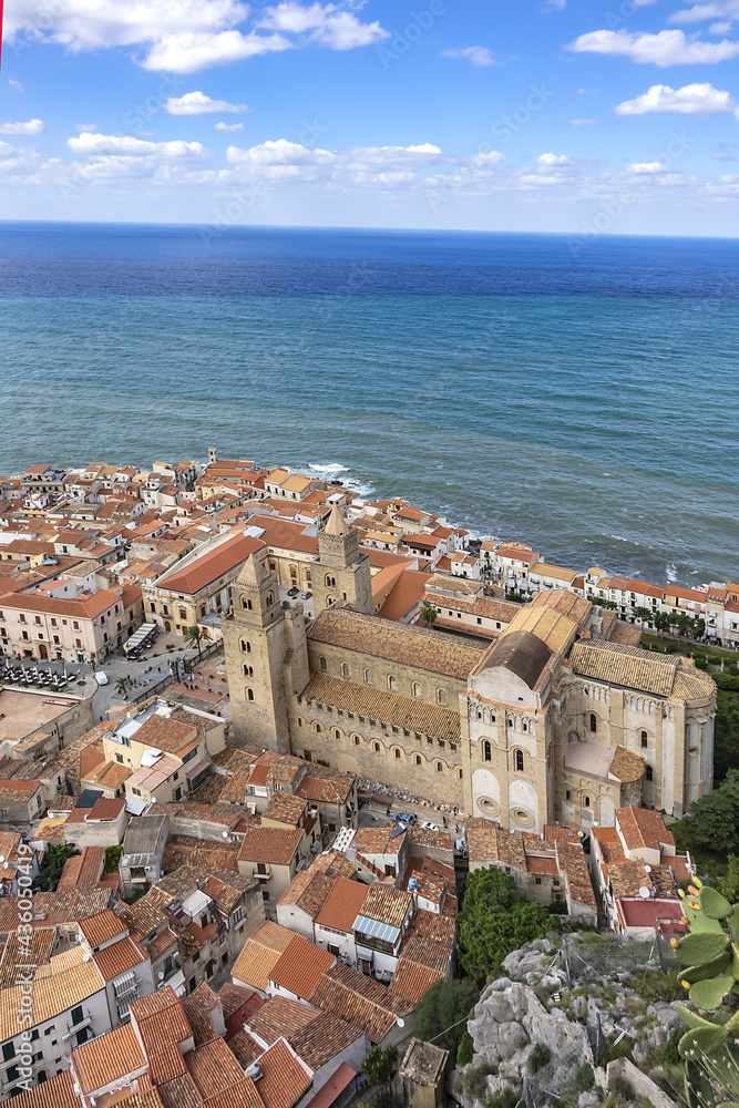 View of Sicilian coastal medieval small city Cefalu (Cephaloedium) with Cefalu Cathedral (Duomo di Cefalu) in foreground from Rocca Mountain. Province of Palermo, Cefalu, Sicily, Italy.