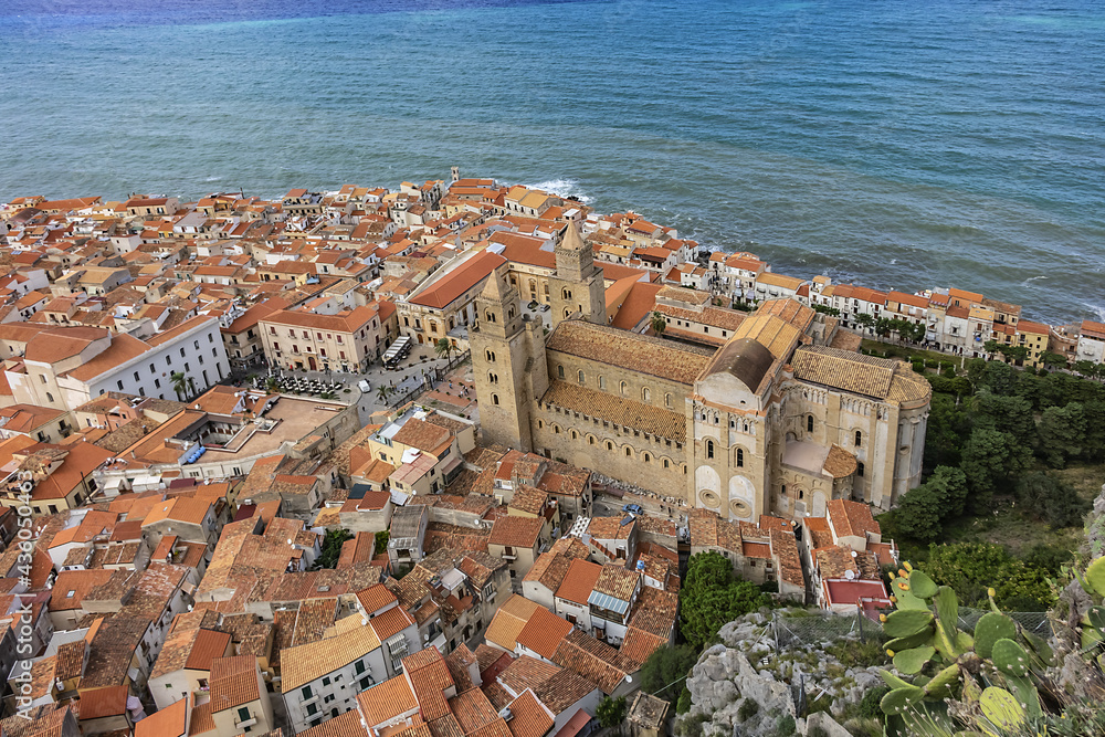 View of Sicilian coastal medieval small city Cefalu (Cephaloedium) with Cefalu Cathedral (Duomo di Cefalu) in foreground from Rocca Mountain. Province of Palermo, Cefalu, Sicily, Italy.