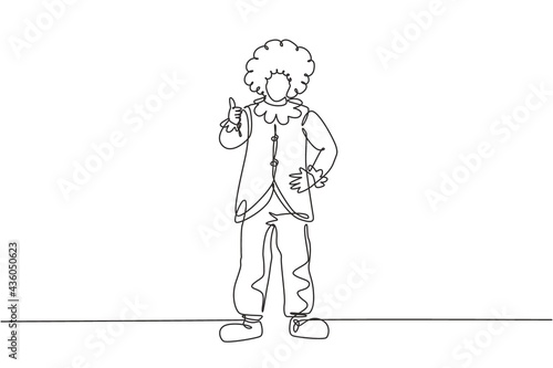 Continuous one line drawing clown stands with a thumbs-up gesture wearing wig and clown costume ready to entertain the audience in the circus arena. Single line draw design vector graphic illustration
