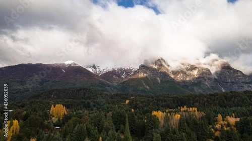 A mountain of clouds runs along Lopez Hill in Bariloche, Argentina during autumn. Hyperlapse drone. photo