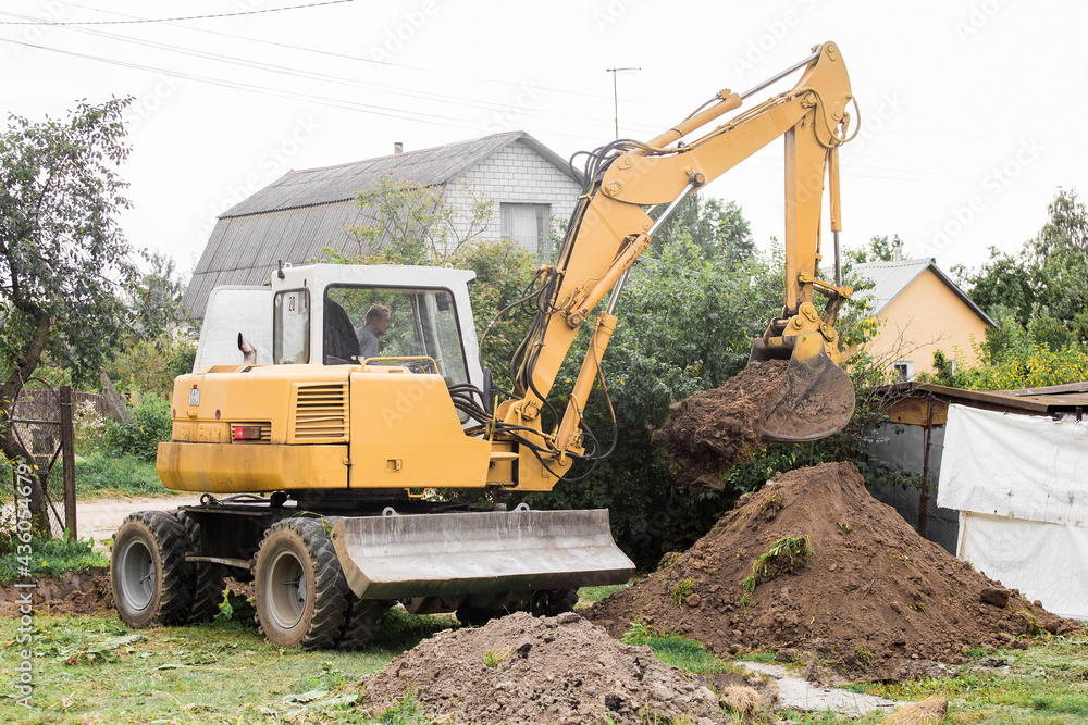 A bulldozer is digging on outdoors in an industrial area. Excavation. Belarus, Minsk region - August 13, 2020 A bulldozer is digging on outdoors in an industrial area. Excavation. Belarus, Minsk region - August 13, 2020