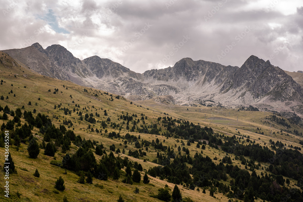 Beautiful view of bare mountain crest with green valley in the Pyrenees Mountains, Andorra
